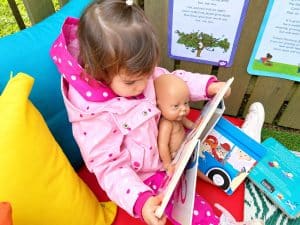 Story time with a doll on the cushions